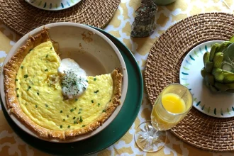 Plato de quiche de camarón decorado con yogurt griego